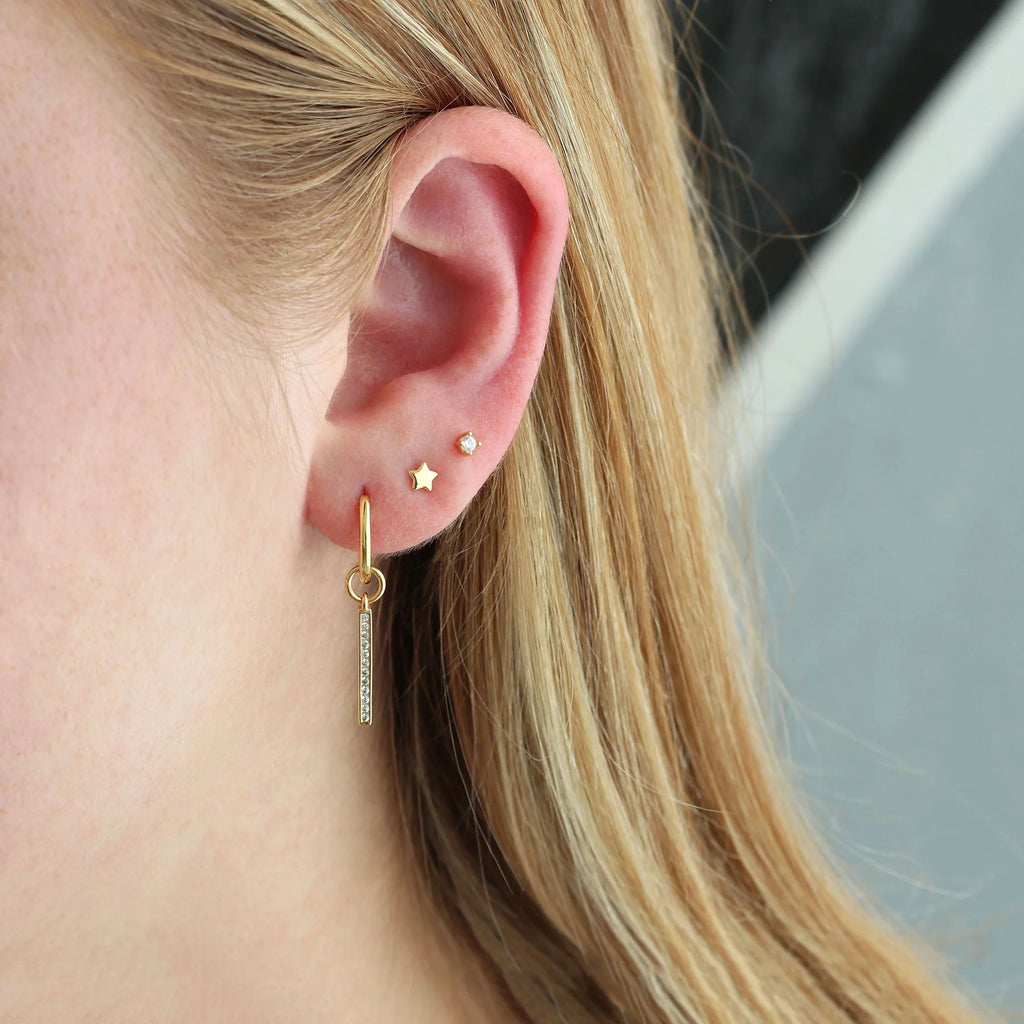 tiny star stud earrings in gold